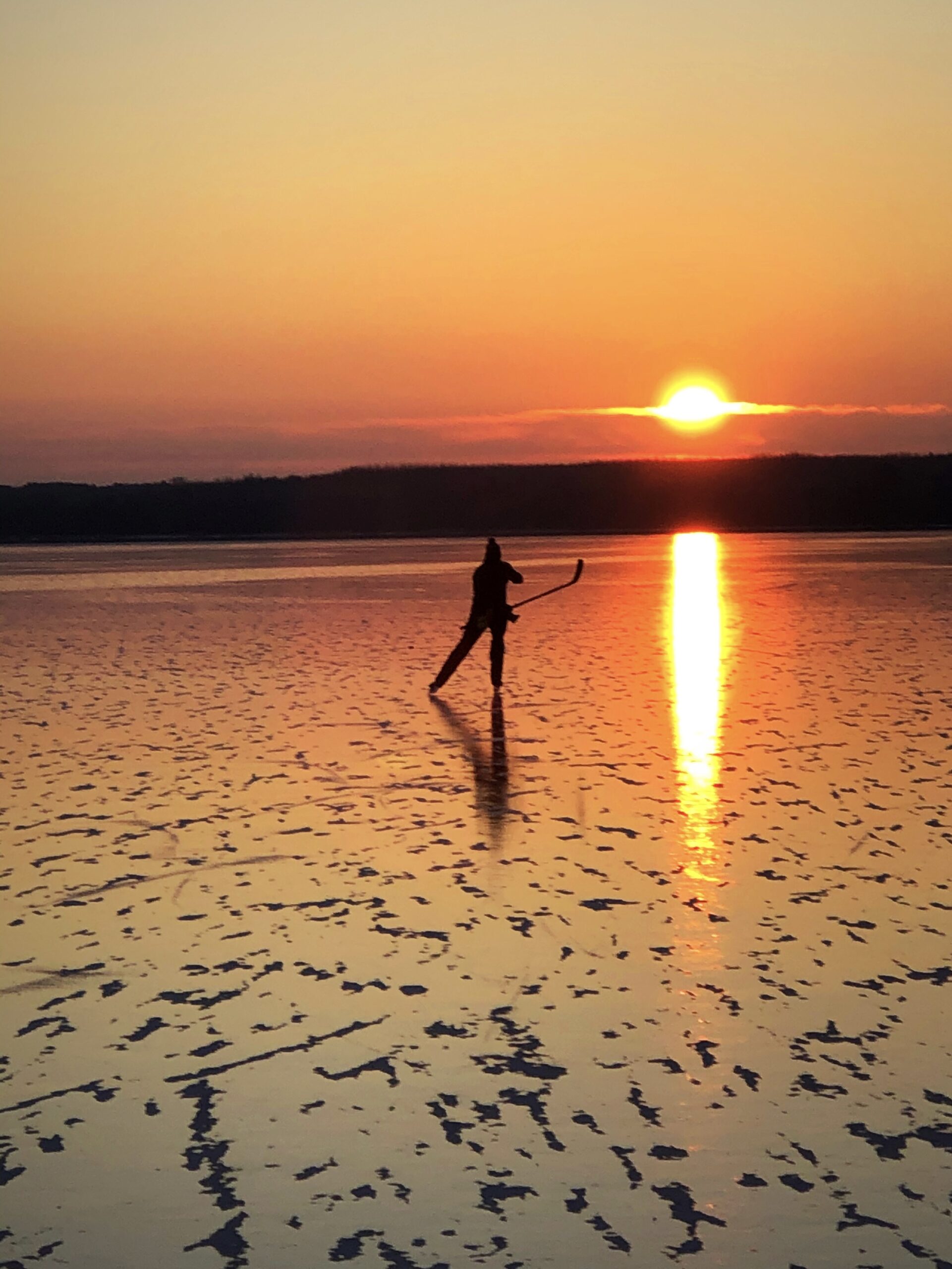 This is a photograph of my friend Mark Morrissey skating at sunrise on a northern Minnesota lake.