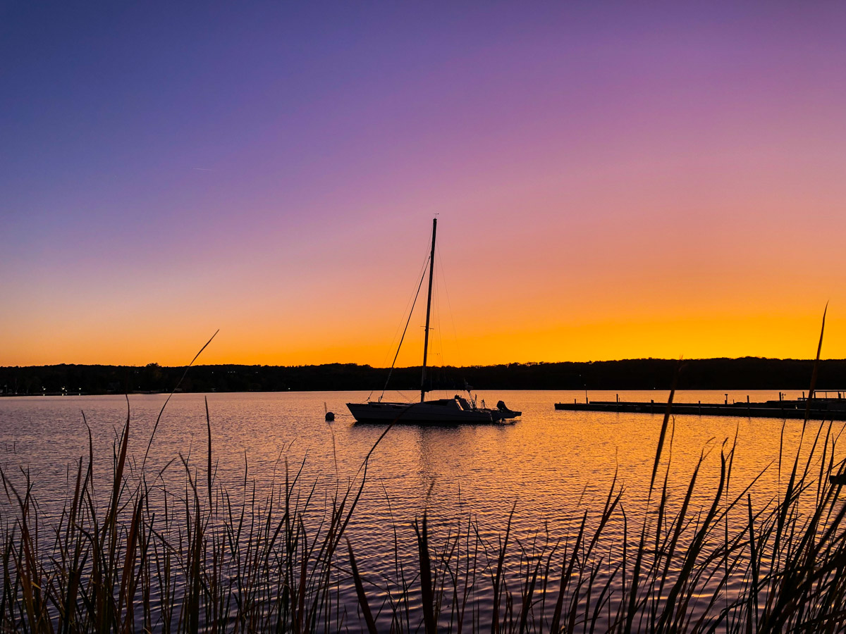 Photo of a boat on a lake at twilight.