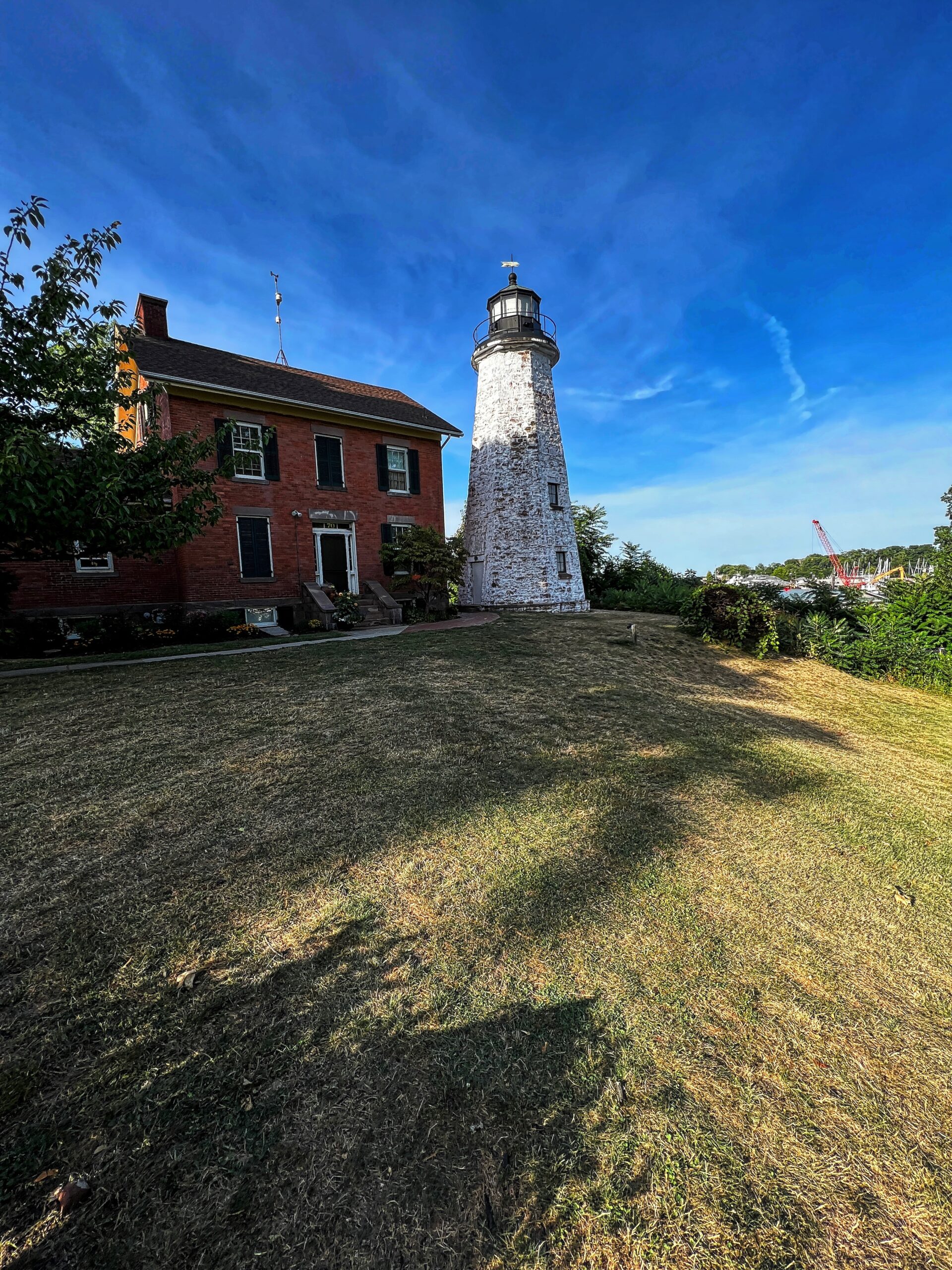 This lighthouse is at the top of a hill overlooking Charlotte Pier and Lake Ontario. Although it was closed, it is known to have a 40-foot-high, spiral staircase, after which one then climbs a ladder to the top to reach an opening in the ceiling to access the lantern room for an amazing view of the lake. 