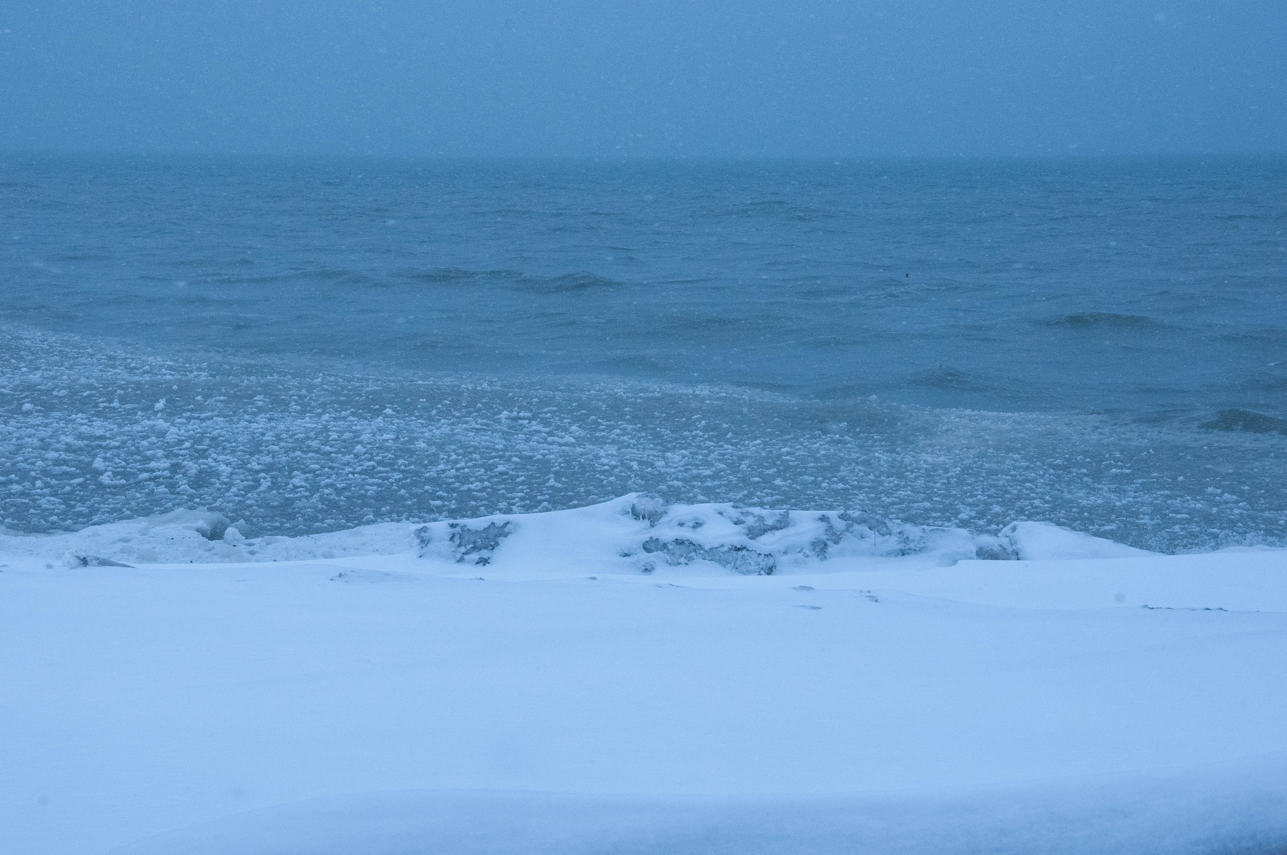 Image depicts Lake Erie where the snow and ice meet the water.
